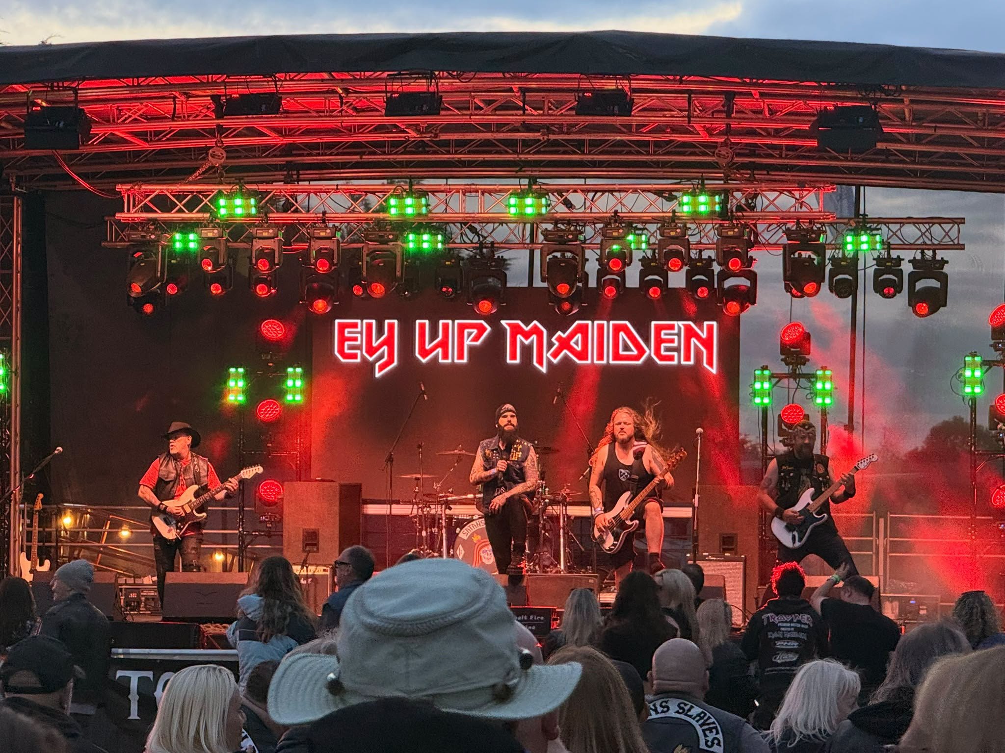 Ey Up Maiden performing live on stage with crowd
