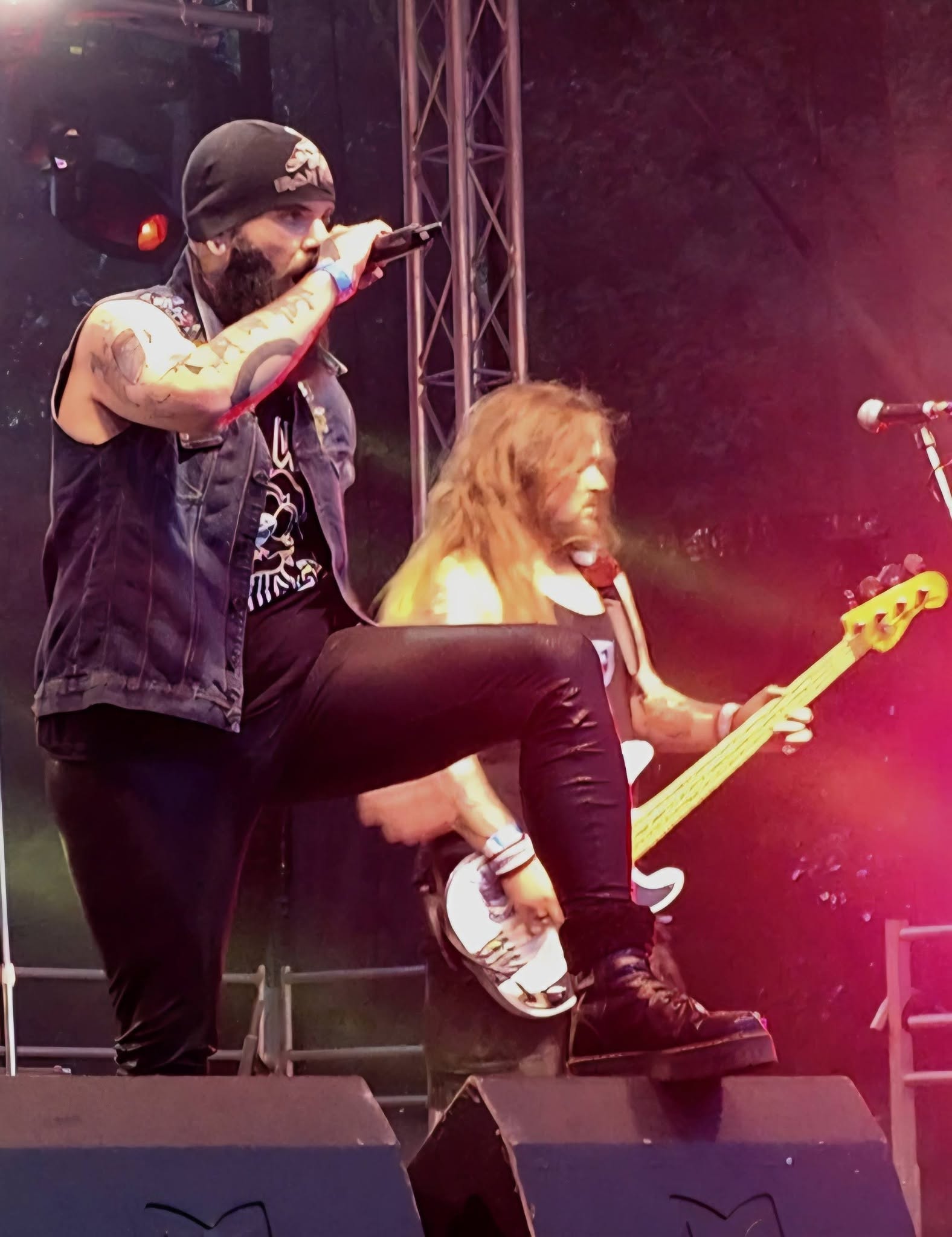 Ey Up Maiden singer with knee up under pink stage light